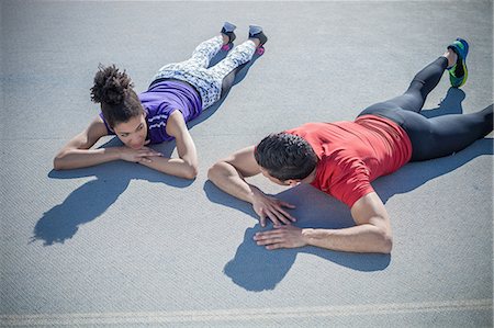 simsearch:649-07279573,k - Overhead view of young man and woman training, taking a break on asphalt Photographie de stock - Premium Libres de Droits, Code: 649-08578005