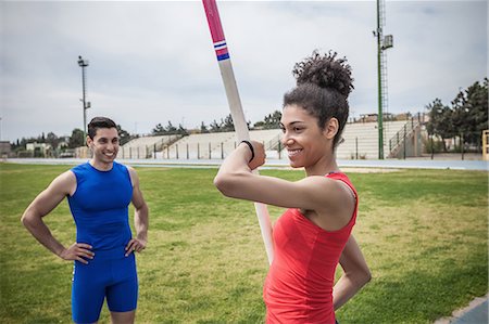 female and male athlete - Instructor advising young female pole vaulter at sport facility Stock Photo - Premium Royalty-Free, Code: 649-08578017