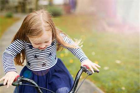 people balancing bicycle picture - Girl riding bicycle Stock Photo - Premium Royalty-Free, Code: 649-08578149