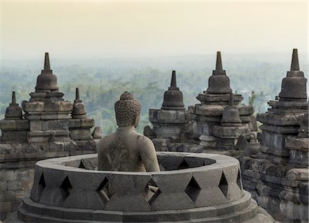 Buddha and rooftops, The Buddhist Temple of Borobudur, Java, Indonesia Stock Photo - Premium Royalty-Free, Code: 649-08632992