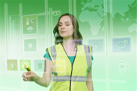 Young woman touching recycling icon on graphical screen Stock Photo - Premium Royalty-Free, Code: 649-08660488
