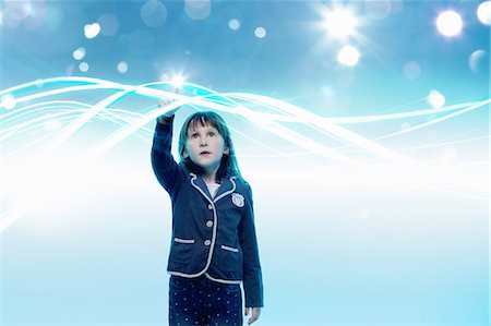 disruptive technology - Young girl reaching out to touch light trails Stock Photo - Premium Royalty-Free, Code: 649-08660495