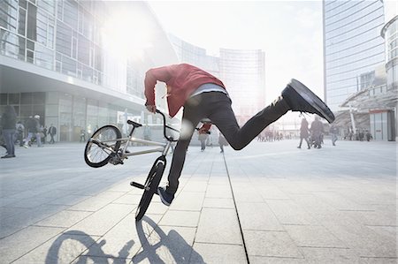 BMX Biker doing stunt in urban area Stock Photo - Premium Royalty-Free, Code: 649-08660662