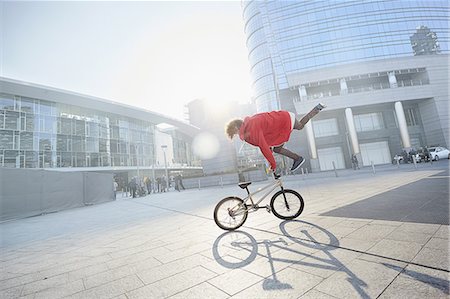 BMX Biker doing stunt in urban area Stock Photo - Premium Royalty-Free, Code: 649-08660670