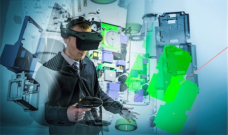 Composite image of engineer wearing VR headset in virtual reality suite Stock Photo - Premium Royalty-Free, Code: 649-08660759