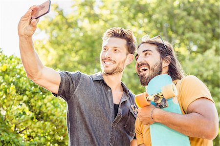 simsearch:614-08535703,k - Man and skateboarder friend taking smartphone selfie in park, Franschhoek, South Africa Stock Photo - Premium Royalty-Free, Code: 649-08661556