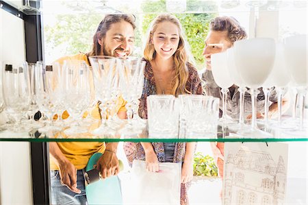 Three adult friends looking at drinking glasses through shop window, Franschhoek, South Africa Stock Photo - Premium Royalty-Free, Code: 649-08661558