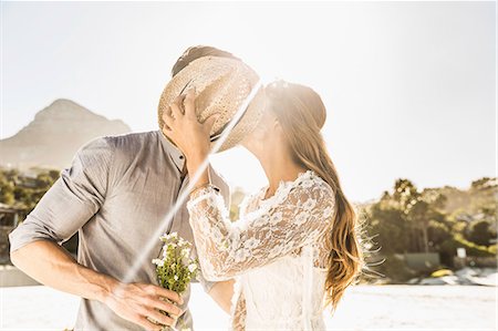 Romantic couple kissing on sunlit beach, Cape Town, South Africa Stock Photo - Premium Royalty-Free, Code: 649-08661943