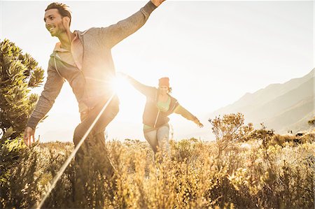 simsearch:649-08824455,k - Couple running in field, arms open Stock Photo - Premium Royalty-Free, Code: 649-08662123