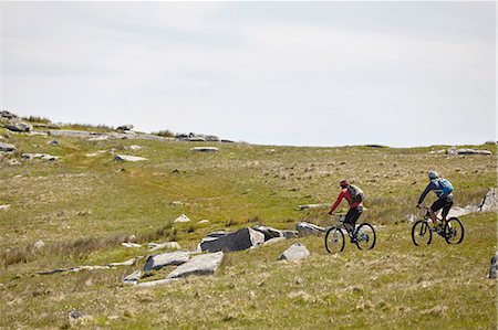 simsearch:649-08702997,k - Cyclists cycling on rocky hillside Photographie de stock - Premium Libres de Droits, Code: 649-08662245