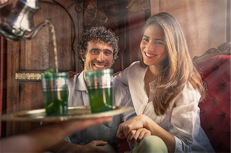 simsearch:862-05998697,k - Young couple in riad being served drinks on tray, Marrakesh, Morocco Stock Photo - Premium Royalty-Free, Code: 649-08662262