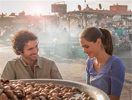 Young couple at food stall in market, Jemaa el-Fnaa Square, Marrakesh, Morocco Stock Photo - Premium Royalty-Free, Code: 649-08662284