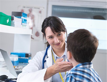 Doctor checking for swollen glands on boy's neck Stock Photo - Premium Royalty-Free, Code: 649-08702108