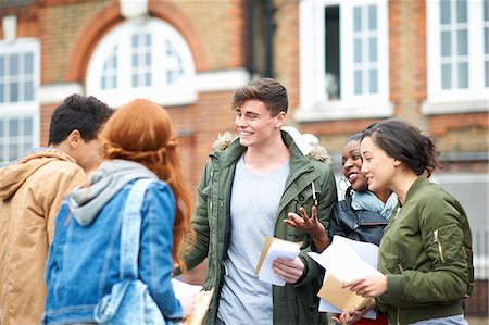 diversity in college campuses - Happy young adult college students congratulating each others exam results on campus Stock Photo - Premium Royalty-Free, Code: 649-08702348