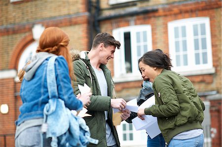 relieved excited person - Happy male and female college students reading exam results on campus Stock Photo - Premium Royalty-Free, Code: 649-08702350
