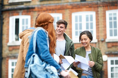relieved excited person - Happy male and female college students reading exam results on campus Stock Photo - Premium Royalty-Free, Code: 649-08702351