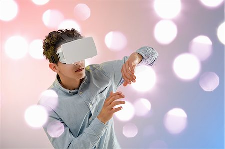 simsearch:649-08702598,k - Young man wearing virtual reality headset Stock Photo - Premium Royalty-Free, Code: 649-08702590