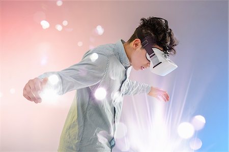 Young man wearing virtual reality headset Stock Photo - Premium Royalty-Free, Code: 649-08702592