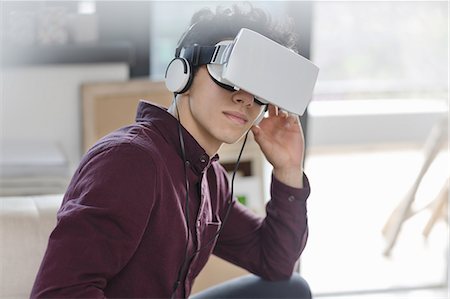 Young man wearing virtual reality headset Stock Photo - Premium Royalty-Free, Code: 649-08702600