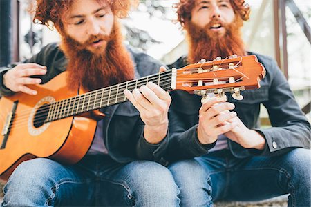 simsearch:649-08702682,k - Young male hipster twins with red beards sitting playing guitar Stock Photo - Premium Royalty-Free, Code: 649-08702622