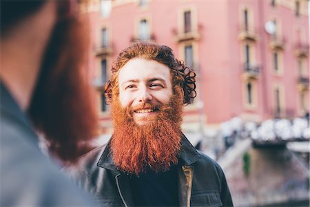 simsearch:649-08702620,k - Young male hipster twins with red hair and beards talking on street Photographie de stock - Premium Libres de Droits, Code: 649-08702661