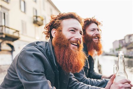 Young male hipster twins with red hair and beards on canal waterfront Stock Photo - Premium Royalty-Free, Code: 649-08702663
