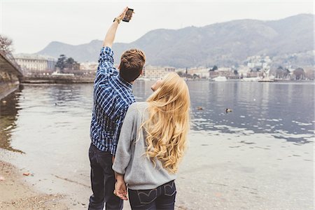 simsearch:649-08702811,k - Young couple taking smartphone selfie on lakeside, Lake Como, Italy Fotografie stock - Premium Royalty-Free, Codice: 649-08702773