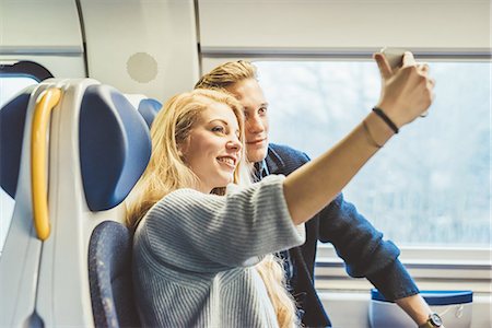 simsearch:649-08702811,k - Young couple taking smartphone selfie in train carriage Stock Photo - Premium Royalty-Free, Code: 649-08702785