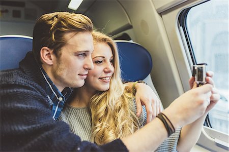 simsearch:649-08702811,k - Young couple photographing through train carriage window, Italy Fotografie stock - Premium Royalty-Free, Codice: 649-08702782