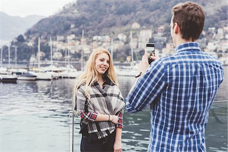 simsearch:649-08702811,k - Young man on waterfront photographing girlfriend,  Lake Como, Italy Fotografie stock - Premium Royalty-Free, Codice: 649-08702827