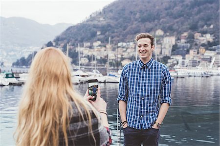 simsearch:649-08702811,k - Young woman on waterfront photographing boyfriend,  Lake Como, Italy Fotografie stock - Premium Royalty-Free, Codice: 649-08702829