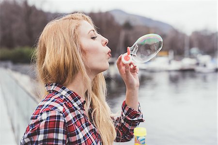 simsearch:649-08824081,k - Young woman on waterfront blowing bubbles,  Lake Como, Italy Stock Photo - Premium Royalty-Free, Code: 649-08702830