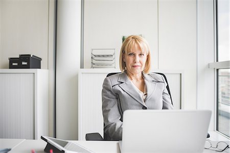 fifty years old blonde - Portrait of mature businesswoman at office desk Stock Photo - Premium Royalty-Free, Code: 649-08702832
