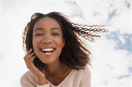 simsearch:649-08702973,k - Happy young woman on windy day Photographie de stock - Premium Libres de Droits, Code: 649-08702955