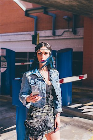 simsearch:649-08060336,k - Young woman with dip dyed blue hair using smartphone in urban housing estate Stock Photo - Premium Royalty-Free, Code: 649-08703303