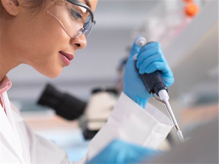 Scientist pipetting a sample into a phial during an experiment in a laboratory Foto de stock - Sin royalties Premium, Código: 649-08703410