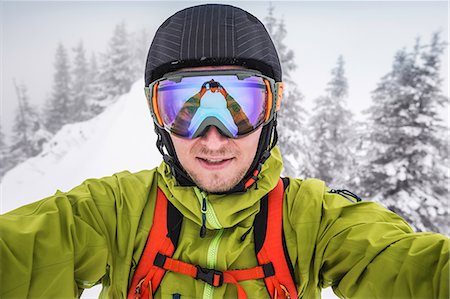 sport and ski - Close up of male skier wearing ski goggles taking selfie on mountain at Kranzegg, Bavaria, Germany Stock Photo - Premium Royalty-Free, Code: 649-08703444