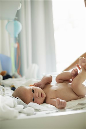 simsearch:649-06830000,k - Naked baby boy lying on changing mat kicking his legs Stock Photo - Premium Royalty-Free, Code: 649-08703488