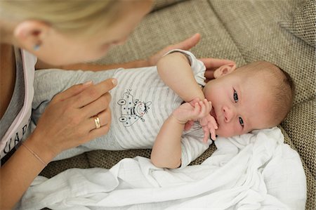simsearch:649-06830000,k - Over the shoulder view of mother nurturing baby son on sofa Stock Photo - Premium Royalty-Free, Code: 649-08703497