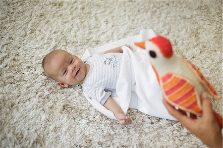 simsearch:649-08661252,k - Happy baby boy looking at toy bird Foto de stock - Royalty Free Premium, Número: 649-08703499