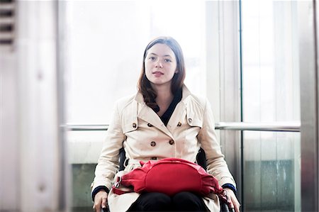 simsearch:649-05658446,k - Portrait of young woman using wheelchair in elevator Photographie de stock - Premium Libres de Droits, Code: 649-08703582