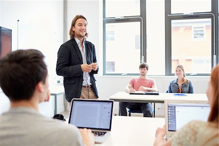 simsearch:649-07648135,k - Male lecturer teaching students using laptops in higher education college classroom Stock Photo - Premium Royalty-Free, Code: 649-08714101