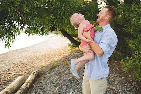 Mid adult man carrying and tickling daughter at Lake Ontario, Oshawa, Canada Stockbilder - Premium RF Lizenzfrei, Bildnummer: 649-08714273