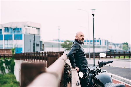 Mature male motorcyclist watching from roadside Stock Photo - Premium Royalty-Free, Code: 649-08714746