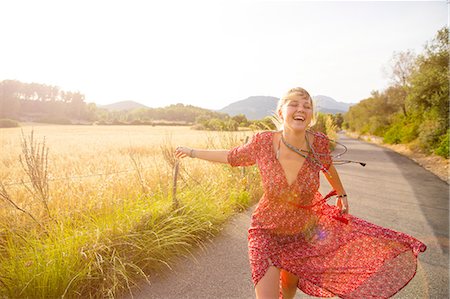 simsearch:649-08565670,k - Young woman running and laughing on rural road, Majorca, Spain Stock Photo - Premium Royalty-Free, Code: 649-08714769