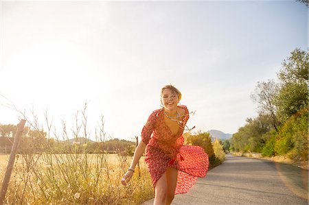 simsearch:649-08565670,k - Happy young woman wearing red dress running on rural road, Majorca, Spain Stock Photo - Premium Royalty-Free, Code: 649-08714770