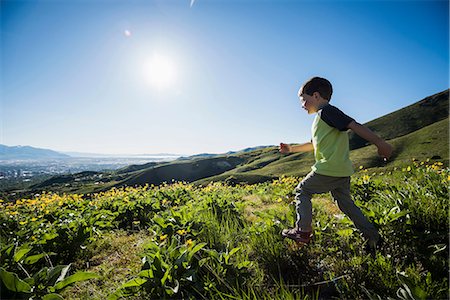 simsearch:614-08487786,k - Young boy running in field, Bonneville Shoreline Trail in the Wasatch Foothills above Salt Lake City, Utah, USA Stock Photo - Premium Royalty-Free, Code: 649-08714797