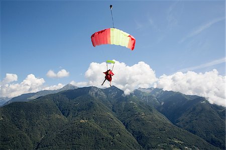 skydiver - Skydiver under her parachute flying free in the blue sky, Locarno, Tessin, Switzerland Stock Photo - Premium Royalty-Free, Code: 649-08714988