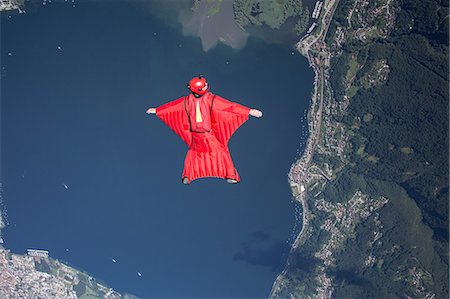sky-diver (male) - Wingsuit skydiver pilot flying over lake, Locarno, Tessin, Switzerland Stock Photo - Premium Royalty-Free, Code: 649-08714990
