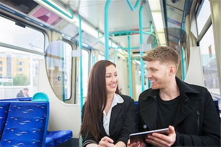 simsearch:649-08327773,k - Businesswoman and businessman using digital tablet in Docklands Light Railway train, London Foto de stock - Sin royalties Premium, Código: 649-08744830